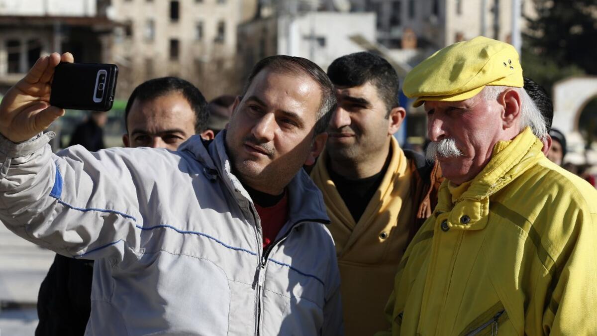 Abu Zakkour, Aleppo's so-called 'yellow man' poses for a selfie photograph in the central Saadallah al-Jabiri square in the northern Syrian city on February 11, 2019. 
LOUAI BESHARA / AFP