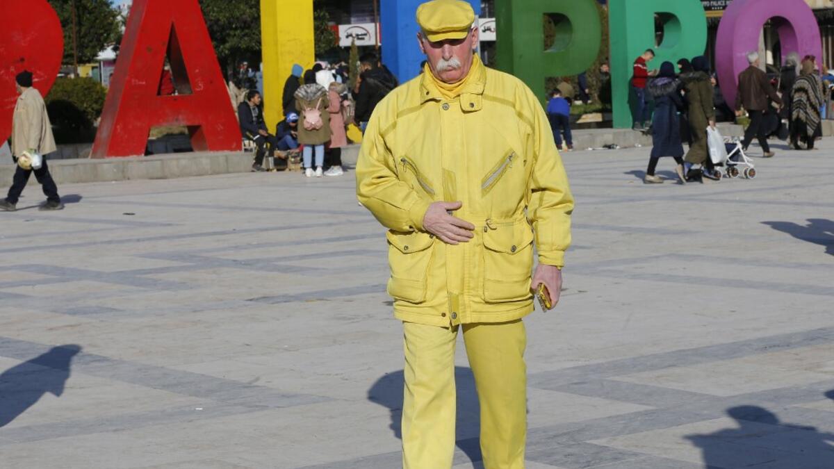 Abu Zakkour, Aleppo's so-called 'yellow man' walks in the central Saadallah al-Jabiri square in the northern Syrian city on February 11, 2019.
LOUAI BESHARA / AFP