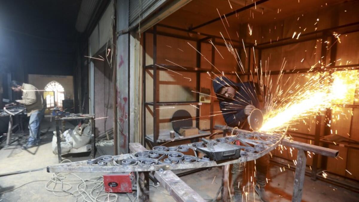 Labourers take part in restoration work at the Saqatiya market in the old quarter of Syria's second city of Aleppo
LOUAI BESHARA / AFP