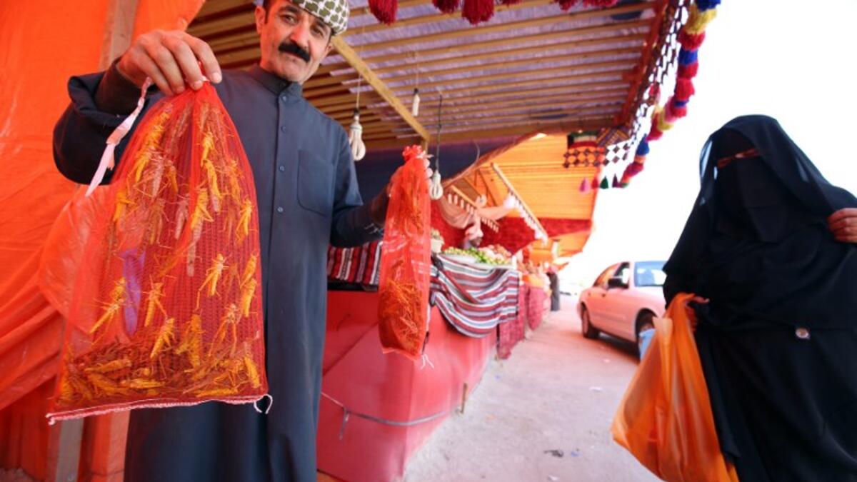 A Kuwaiti vendor holds bags filled with locusts, sold as food, at a market in Kuwait City 
Yasser Al-Zayyat / AFP
