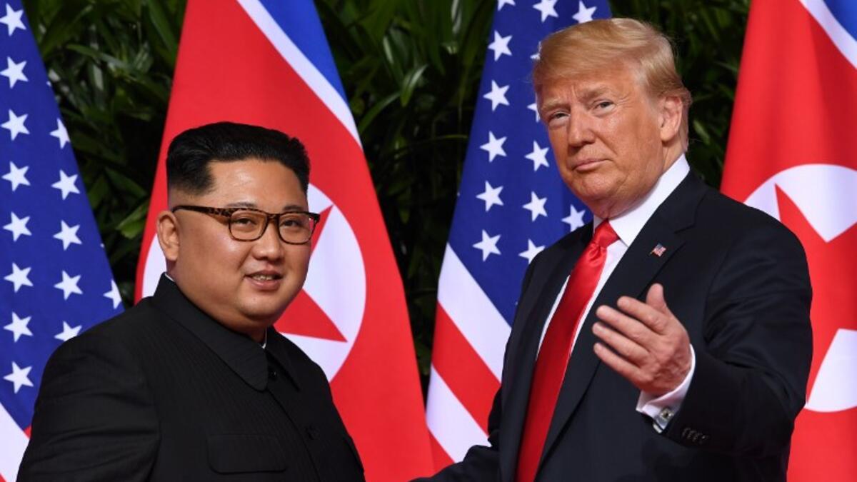 This file photo taken on June 12, 2018 shows US President Donald Trump (R) gesturing as he meets with North Korea's leader Kim Jong Un (L) at the start of their historic US-North Korea summit, at the Capella Hotel on Sentosa island in Singapore. 
SAUL LOEB / AFP