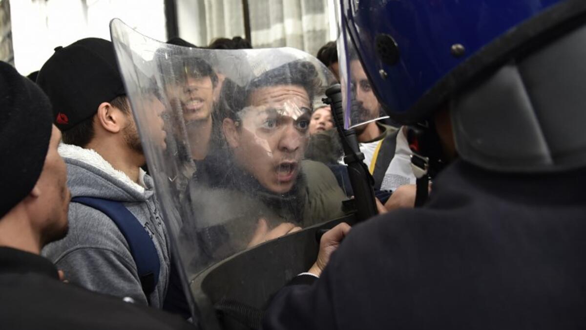 Algerian students scuffle with security forces during a protest in the capital Algiers against ailing President Abdelaziz Bouteflika's bid for a fifth term
RYAD KRAMDI / AFP