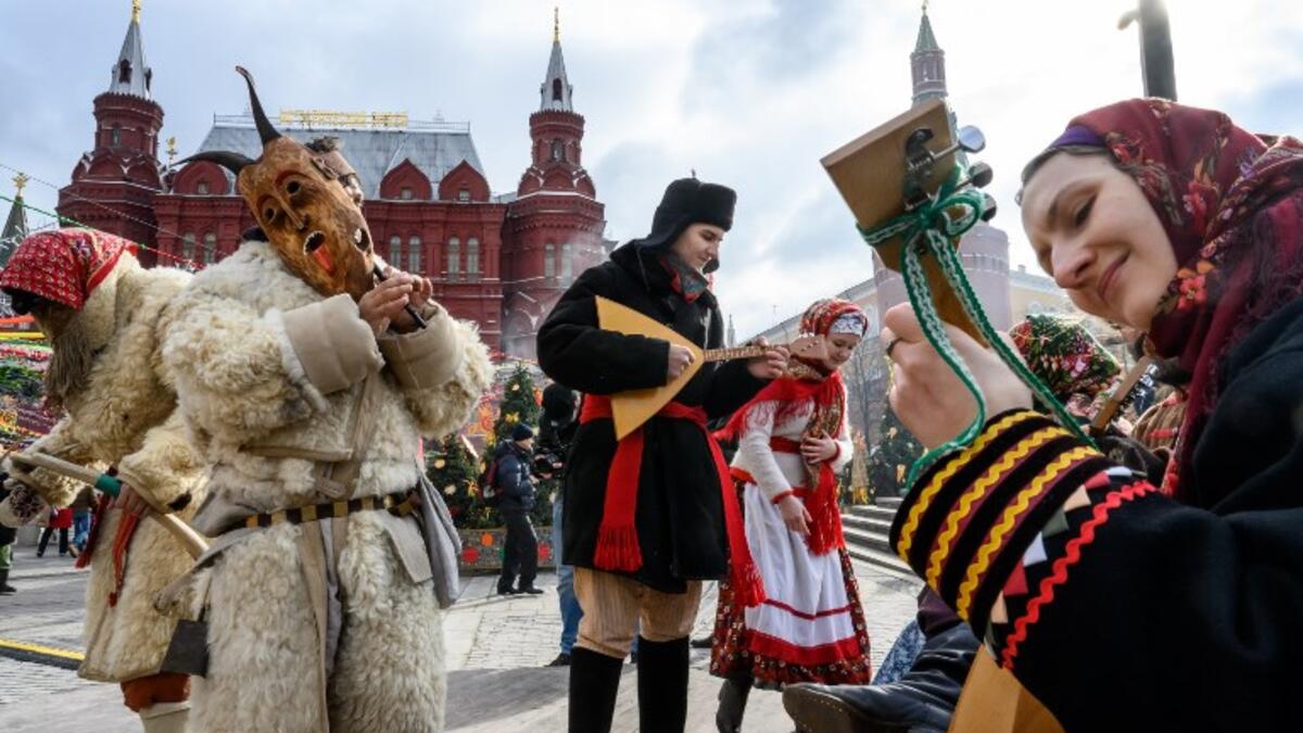 Performers dressed in traditional costumes sing and dance during the Shrovetide spring festival outside the Kremlin in Moscow on March 01, 2019. Mladen ANTONOV / AFP