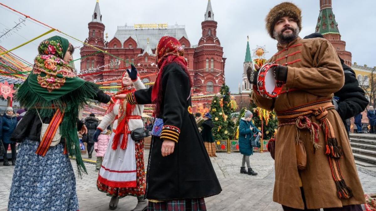 Performers dressed in traditional costumes sing and dance during the Shrovetide spring festival outside the Kremlin in Moscow on March 01, 2019. Mladen ANTONOV / AFP