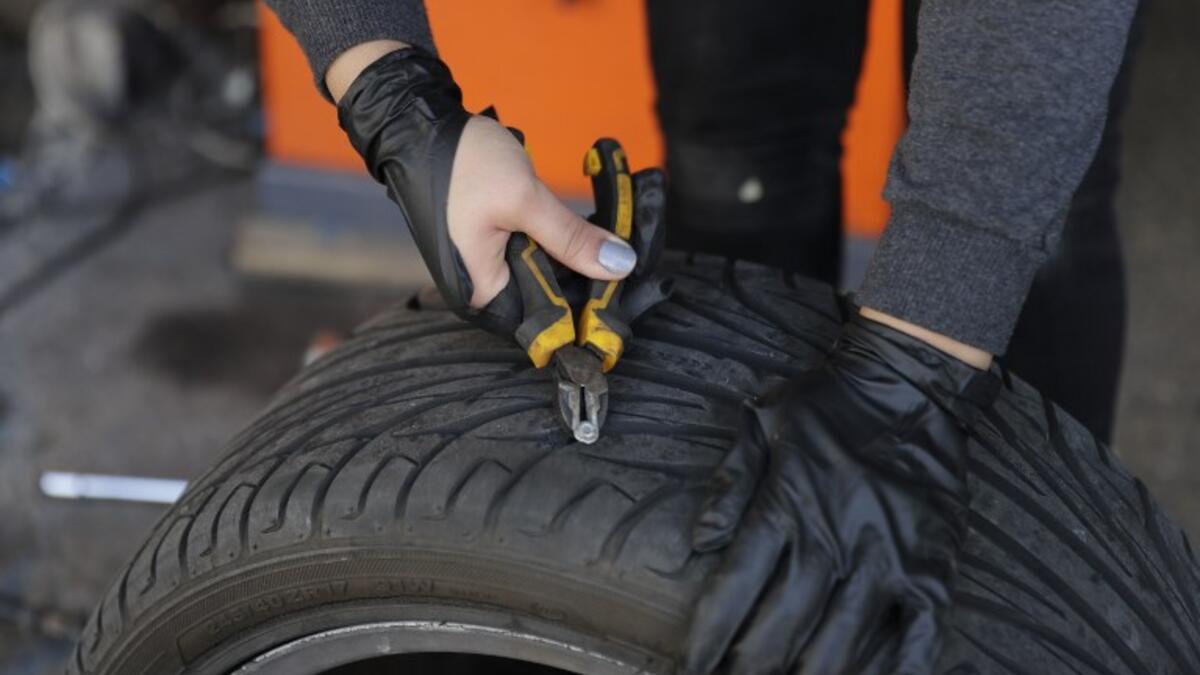 Amina repairs a flat tyre at a car tyre's repair shop in Beirut on March 8, 2019. Amina has been working for 10 years in mechanics, specially in the tyres repair business. She considers it fulfilling as she always dreamt of doing that job.
JOSEPH EID / AFP