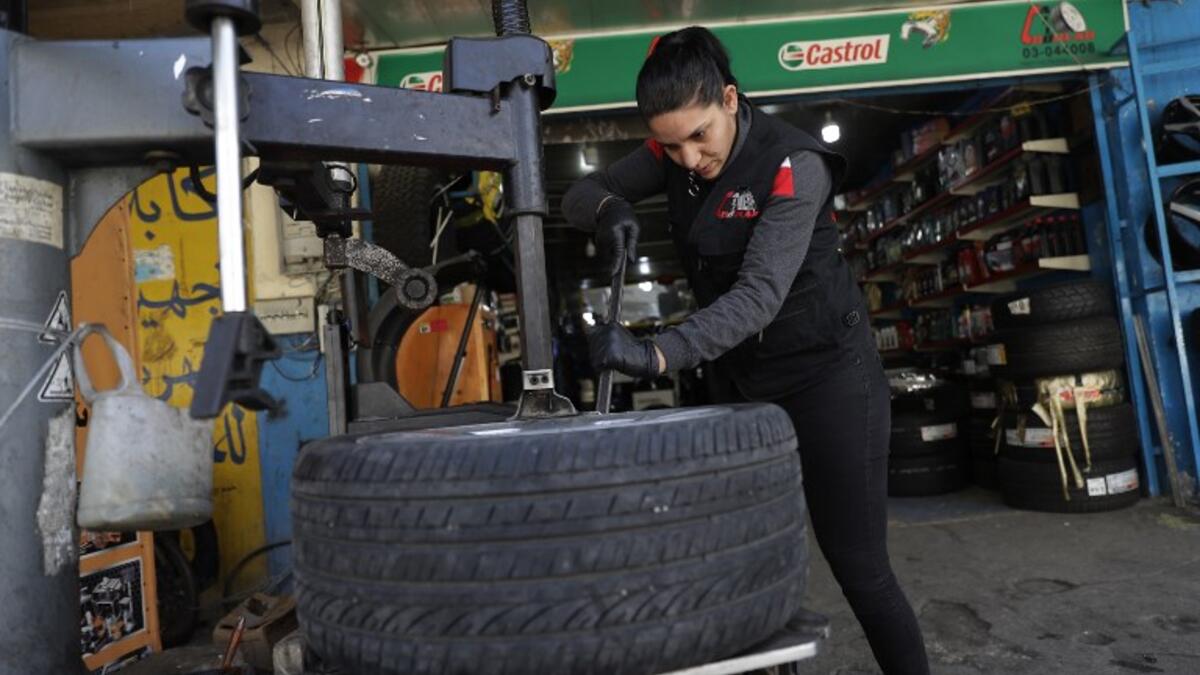 Amina repairs a flat tyre at a car tyre's repair shop in Beirut on March 8, 2019. Amina has been working for 10 years in mechanics, specially in the tyres repair business. She considers it fulfilling as she always dreamt of doing that job.
JOSEPH EID / AFP