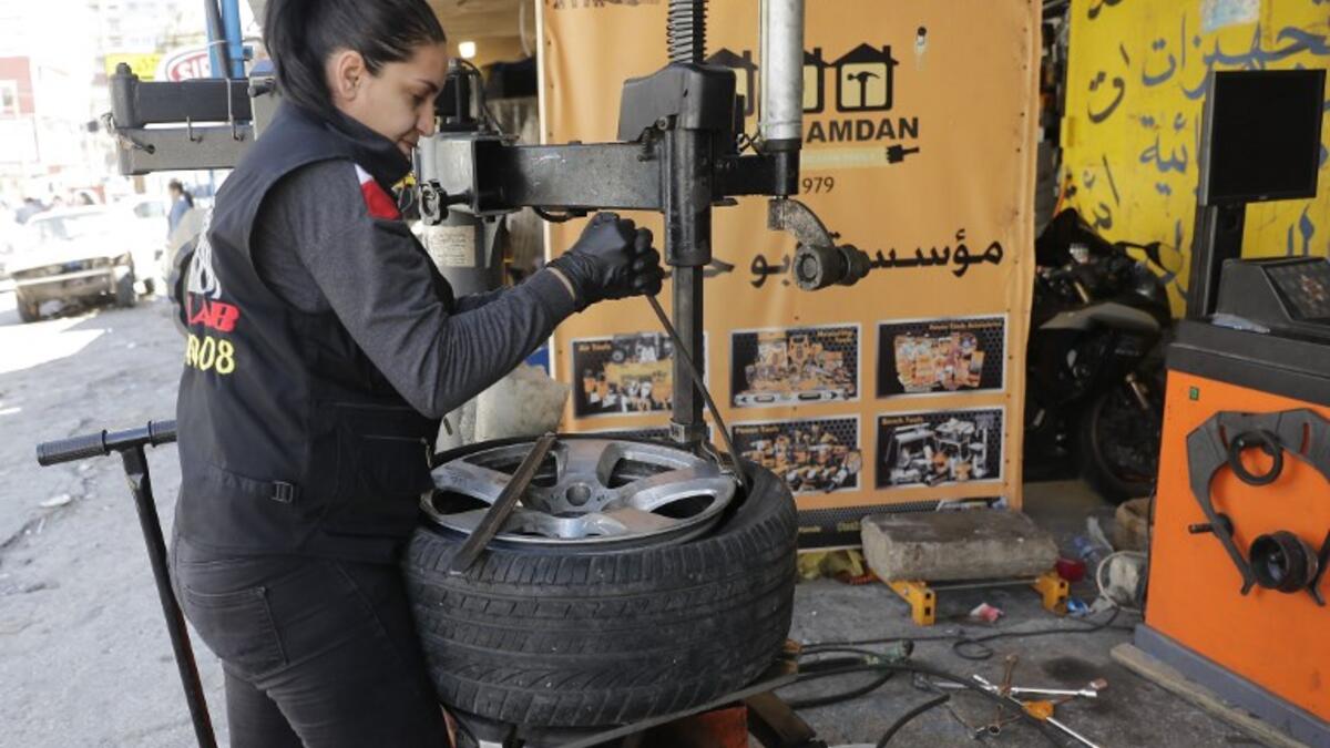 Amina repairs a flat tyre at a car tyre's repair shop in Beirut on March 8, 2019. Amina has been working for 10 years in mechanics, specially in the tyres repair business. She considers it fulfilling as she always dreamt of doing that job.
JOSEPH EID / AFP
