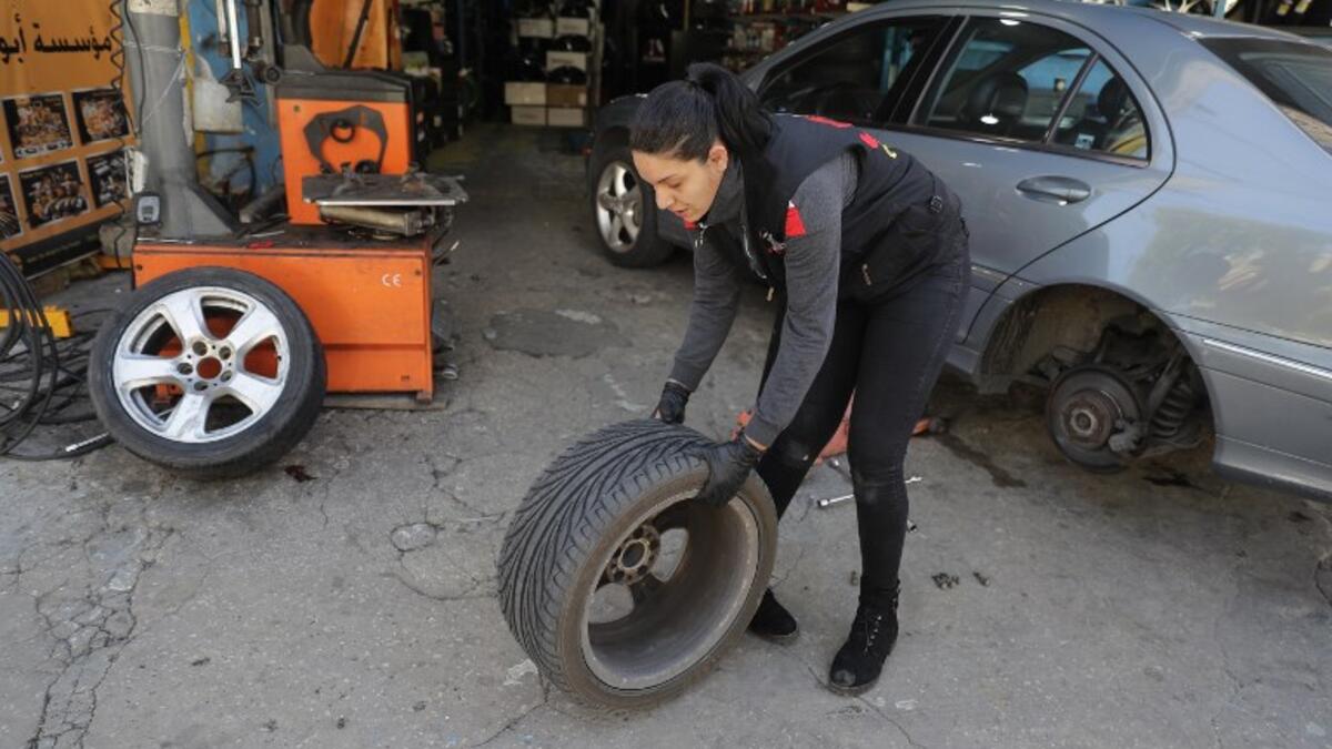 Amina repairs a flat tyre at a car tyre's repair shop in Beirut on March 8, 2019. Amina has been working for 10 years in mechanics, specially in the tyres repair business. She considers it fulfilling as she always dreamt of doing that job.
JOSEPH EID / AFP