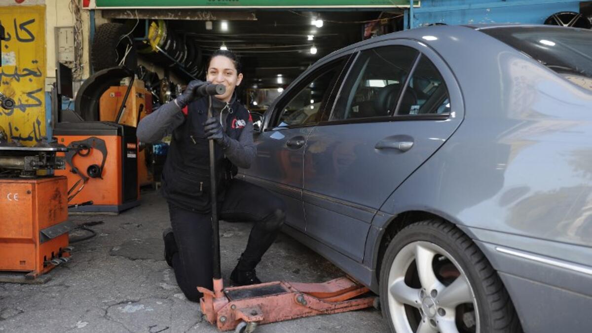 Amina repairs a flat tyre at a car tyre's repairshop in Beirut on March 8, 2019. Amina has been working for ten years in mechanics, specially in the tyres repair business. She considers it a fulfilement as she always dreamt of doing that job.
JOSEPH EID / AFP