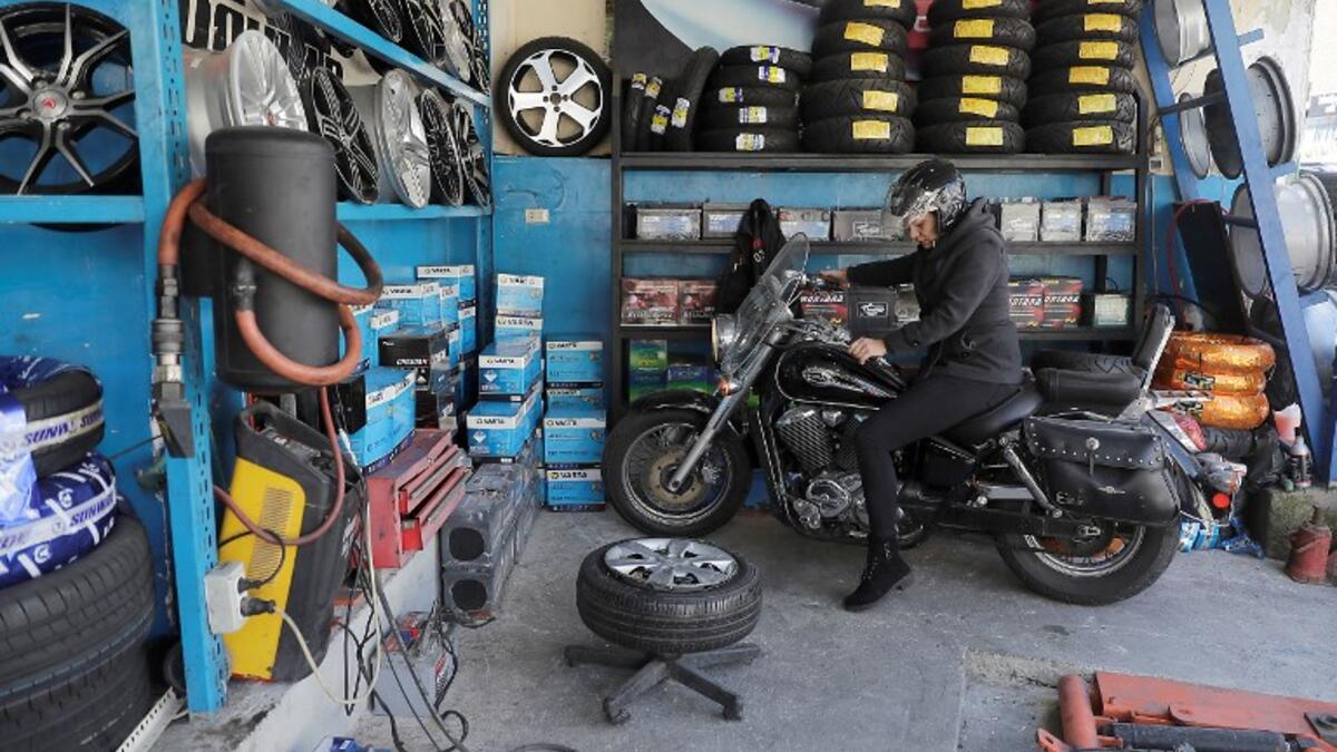 Amina repairs a motorbike's flat tyre at a tyre's repair shop in Beirut on March 8, 2019. Amina has been working for ten years in mechanics, specially in the tyres repair business. She considers it fulfilling as she always dreamt of doing that job.
JOSEPH EID / AFP