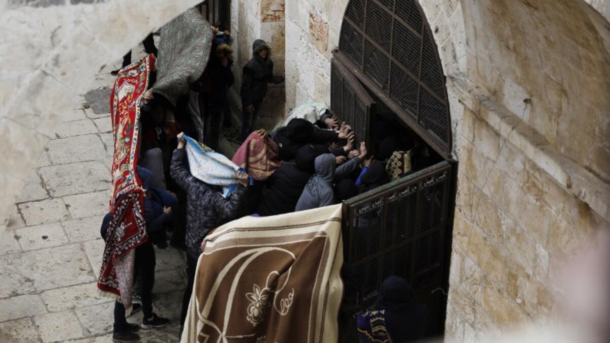 Palestinian protesters break a door of the Golden Gate or Gate of Mercy inside the Al-Aqsa mosques compound in Jerusalem's Old City 
AHMAD GHARABLI / AFP