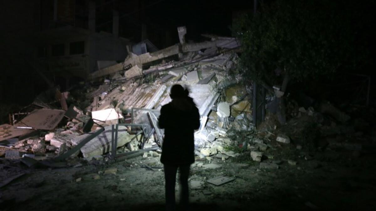 A man stares at building that collapsed from reported Israeli strikes in Gaza City on March 25, 2019. 
MOHAMMED ABED / AFP