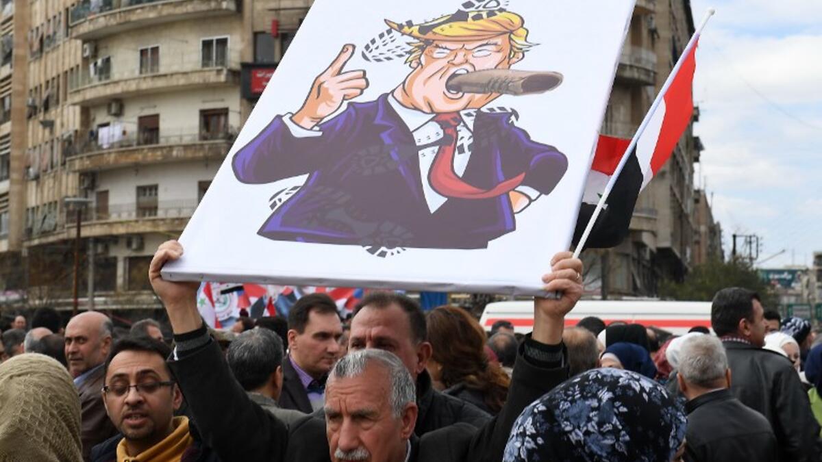 Syrians protest in the northern city of Aleppo against the US decision to recognise Israel's sovereignty over the Golan Heights on March 26, 2019. 
GEORGE OURFALIAN / AFP