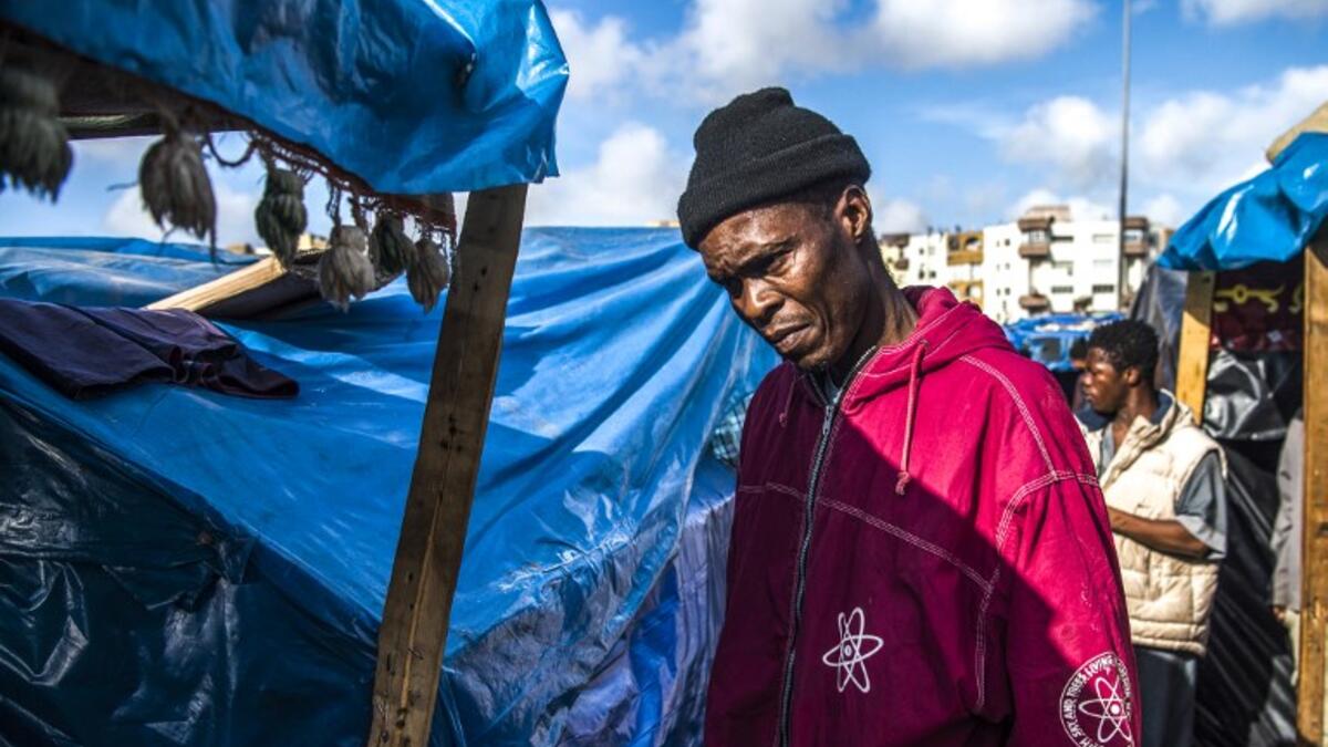 A sub-Saharan migrant walks between make-shift tents in the Oulad Ziane migrant camp in Casablanca on March 27, 2019. 
FADEL SENNA / AFP