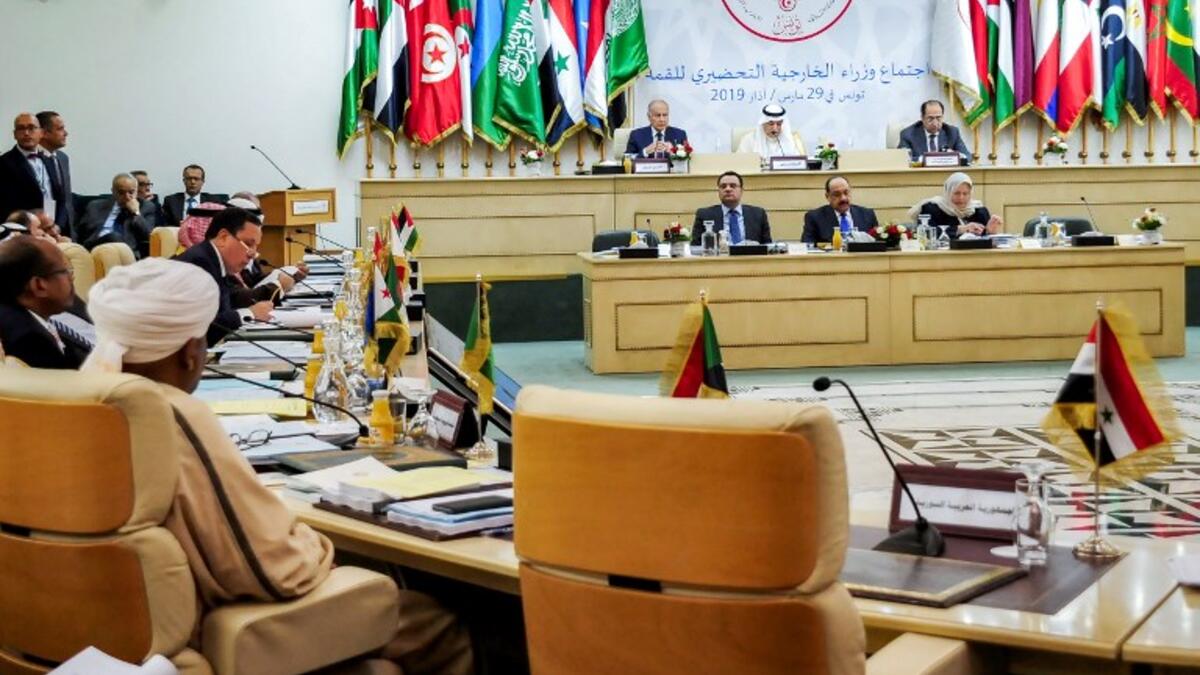 This picture taken on March 29, 2019 shows a view of the preparatory meeting for Arab foreign ministers in the Tunisian capital Tunis, ahead of the 30th annual Arab League summit, with the vacant seat for the Syrian Arab Republic seen in the foreground (R). 
FETHI BELAID / AFP
