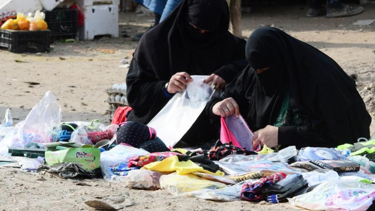 Displaced women sell clothing items in the souk or market of Al-Hol camp for displaced people in northeastern Syria
GIUSEPPE CACACE / AFP