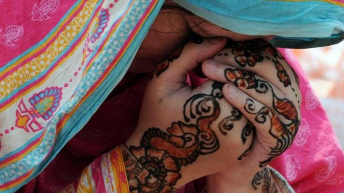 A Pakistani Muslim woman prays during Eid al-Fitr prayers at the Badshahi Masjid Mosque on August 9, 2013. (AFP)