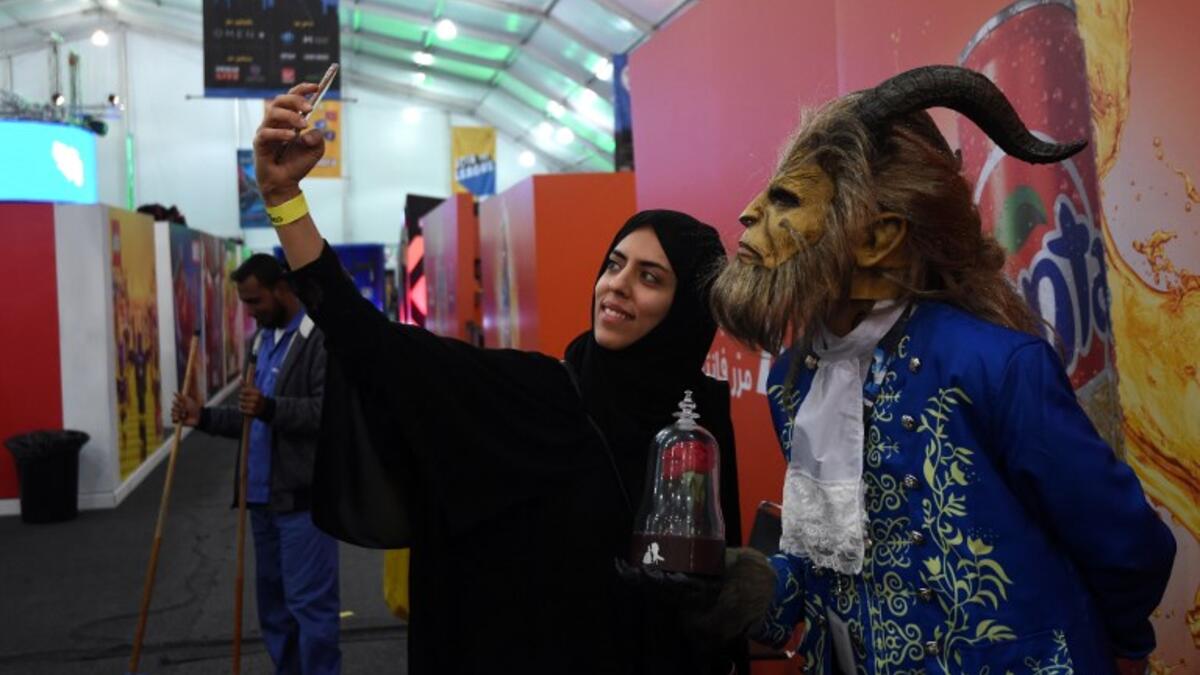 A Saudi woman uses her cell phone to take a "selfie" photograph with a cosplayer dressed as the Beast from Disney's 2017 live-action "Beauty and the Beast" film, as they attend the first ever Comic-Con Arabia event held in the capital Riyadh on November 25, 2017. 
(FAYEZ NURELDINE / AFP)