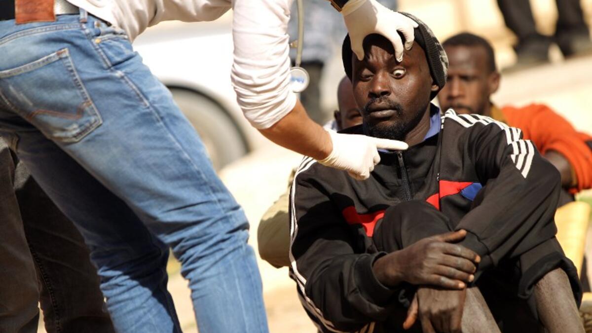 A sub-Saharan migrant undergoes a medical check-up before being repatriated from the Qanfouda detention center, in the southern outskirts of Benghazi, on Dec. 2, 2017. 
(Abdullah DOMA / AFP)