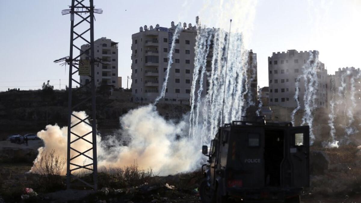 Israeli forces fire teargas at Palestinian demonstrators during clashes near an Israeli checkpoint in the West Bank city of Ramallah.
(ABBAS MOMANI / AFP)