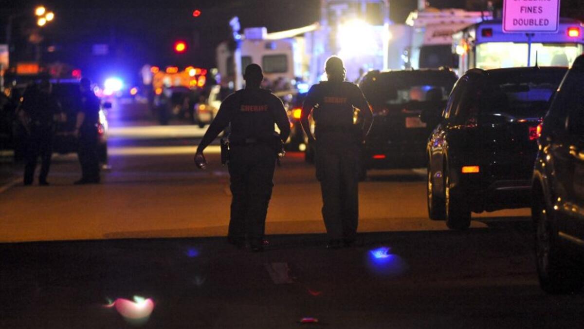 Police vehicles block the road to Marjory Stoneman Douglas High School in Parkland, Florida, following a shooting that killed 17 people on Feb. 14, 2018 in Parkland, Florida. (Gaston De Cardenas / AFP)