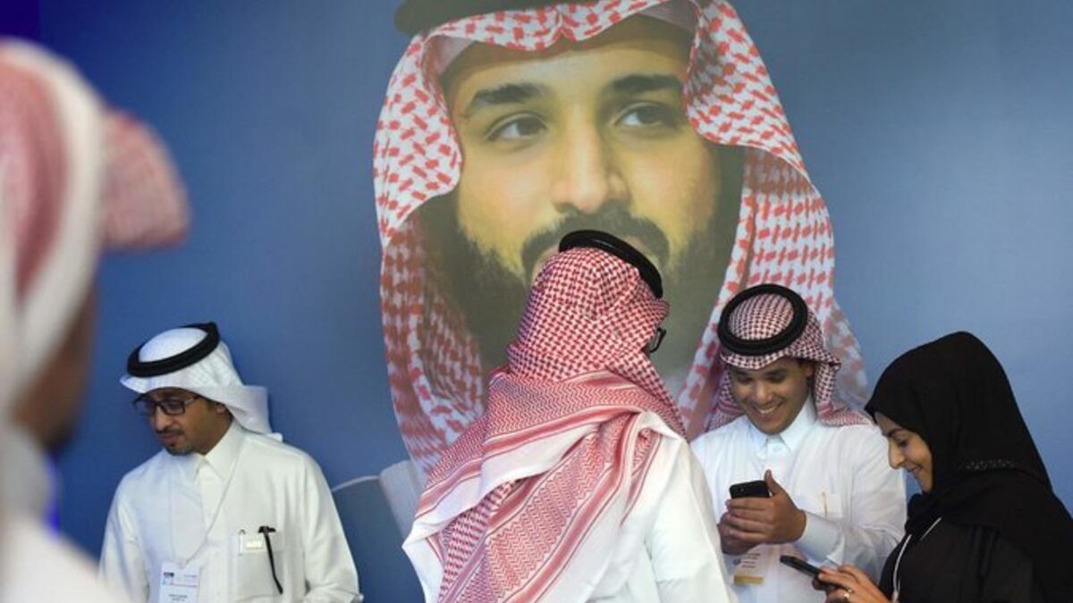 Bader Al Asaker, who heads the crown prince’s personal foundation, at left with white head covering, is one of three shareholders listed for Eight Investment, which owns the chateau. (AFP)