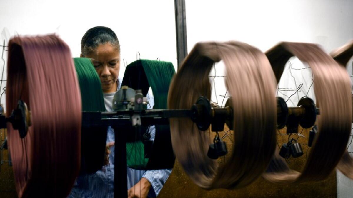 This picture shows a woman at work in the laboratory of the ancient silk factory of Antico setificio Fiorentino in Florence. 
Tiziana FABI / AFP