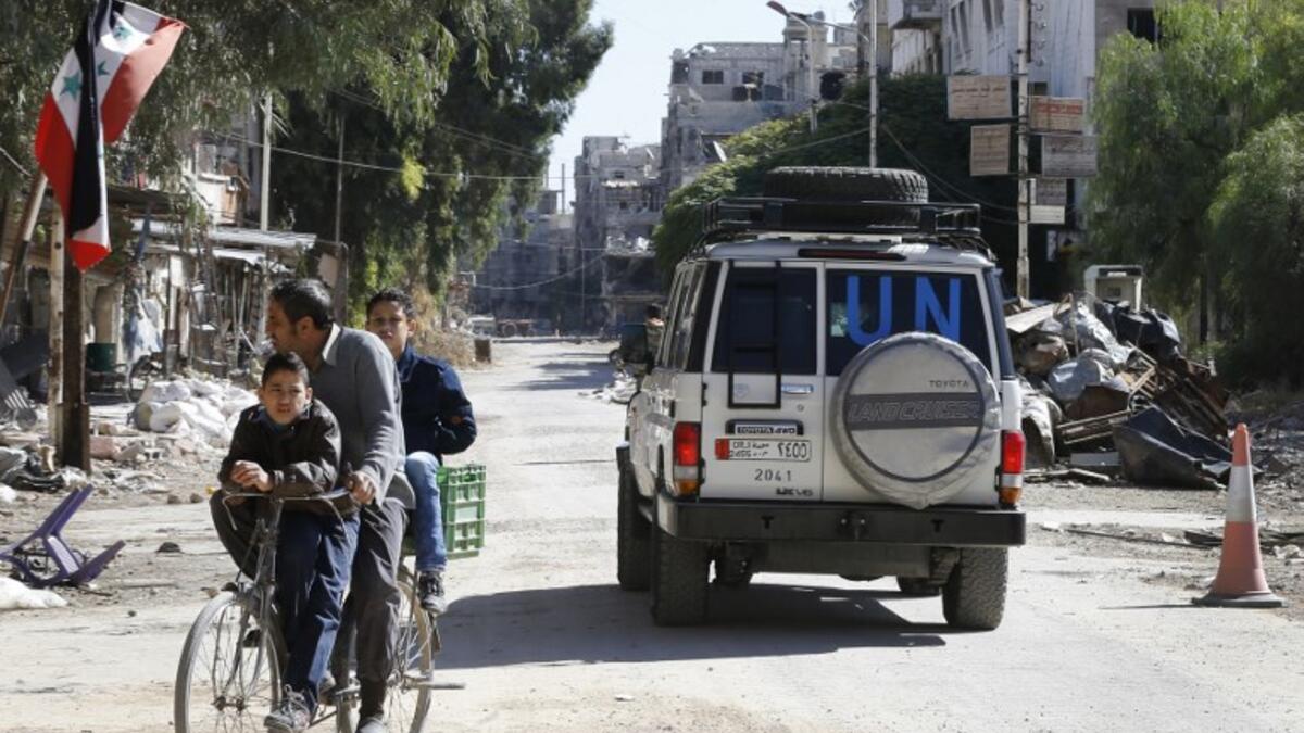 A vehicle of the UN agency for Palestinian refugees (UNRWA) drives through a street in Yarmuk camp southern Damascus on November 1, 2018. 
LOUAI BESHARA / AFP