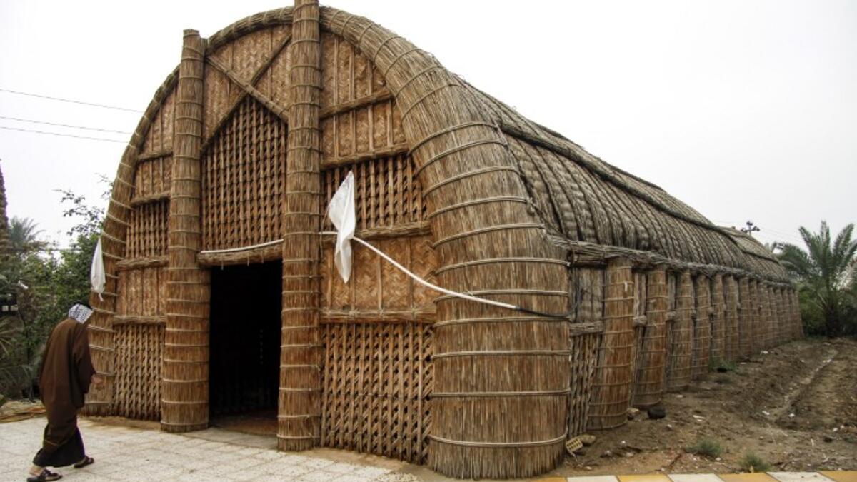 A member of an Iraqi clan enters a straw tent in the town of Mishkhab, south of Najaf on November 15, 2018. 
Haidar HAMDANI / AFP