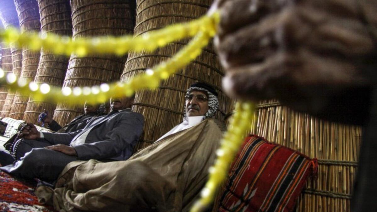 Members of an Iraqi clan gather inside a straw tent in the town of Mishkhab, south of Najaf on November 15, 2018. 
Haidar HAMDANI / AFP