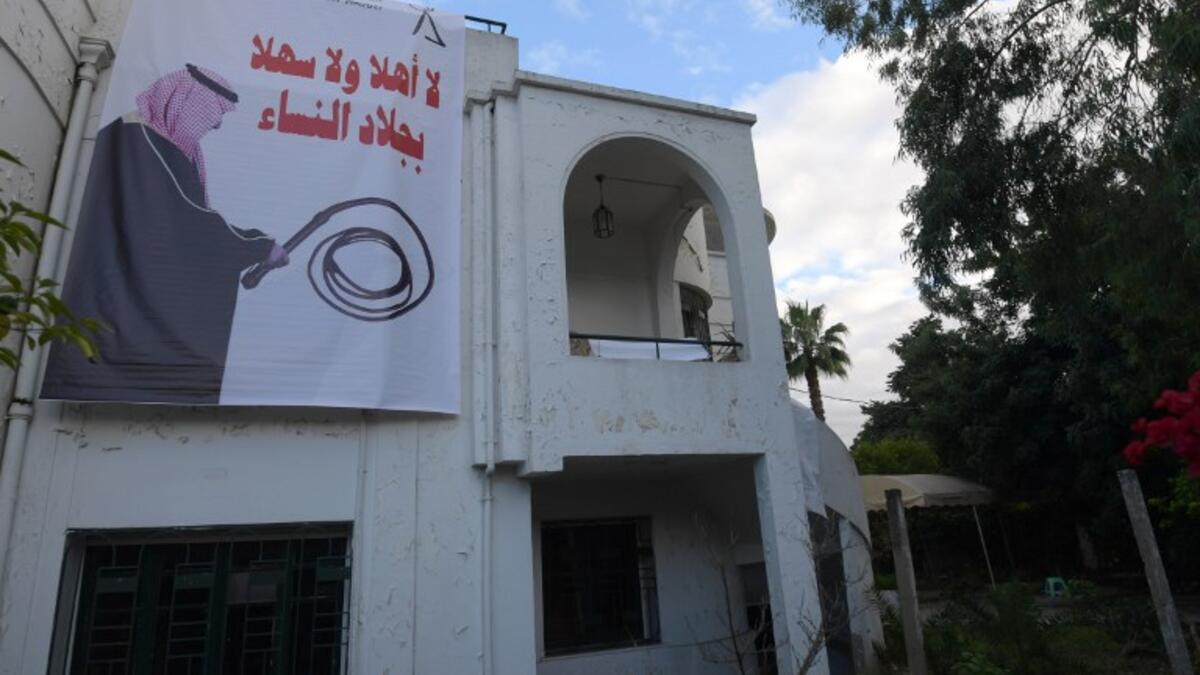 A picture taken on November 26, 2018 shows a banner hanging at the headquarters of Tunisia's Democratic Women association in the capital Tunis depicting Saudi Crown Prince Mohammed bin Salman holding a whip with a caption in Arab above reading "torturer, is not welcome".
FETHI BELAID / AFP
