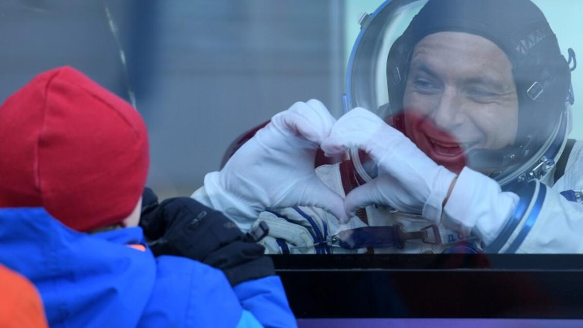 David Saint-Jacques of the Canadian Space Agency, a member of the International Space Station (ISS) expedition 58/59, gestures from inside a bus as he leaves to board the Soyuz MS-11 spacecraft shortly before the launch at the Russian-leased Baikonur cosmodrome in Kazakhstan on December 3, 2018. 
Kirill KUDRYAVTSEV / AFP