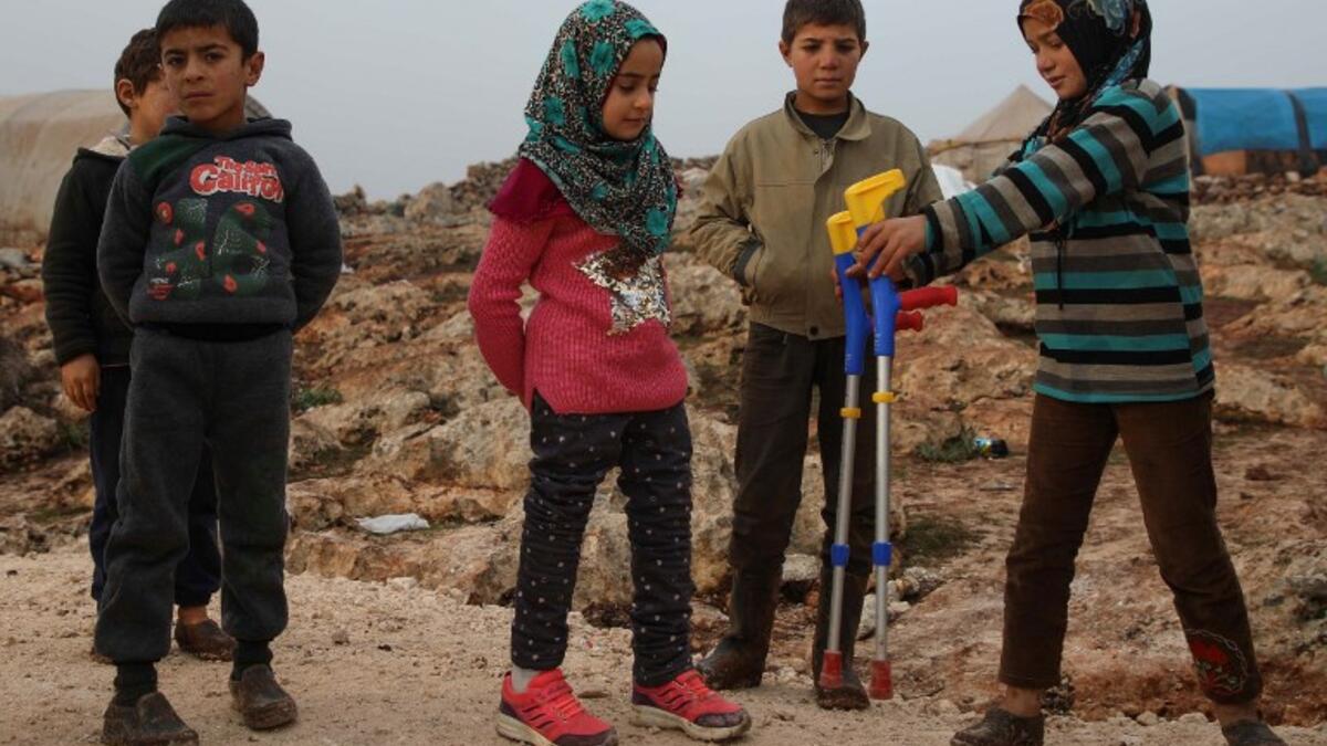 Maya Merhi (C) stands among her friends in the Internally Displaced Persons (IDP) camp of Serjilla in northwestern Syria, next to Bab al-Hawa border crossing with Turkey.
Aaref WATAD / AFP