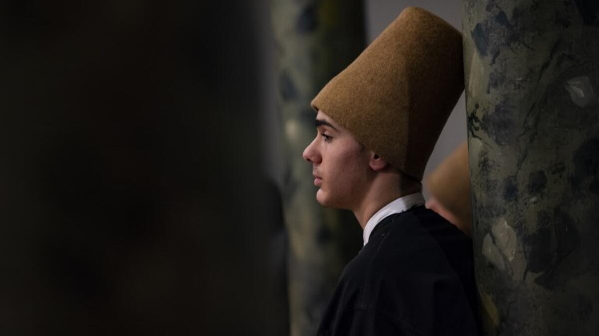 A dervish looks on during a ceremony marking the anniversary of the death of Jelaleddin Mevlana Rumi, Sufi mystic, poet and founder of the sufism on December 16, 2018 at Galata Mevlihanesi in Istanbul. Yasin AKGUL / AFP