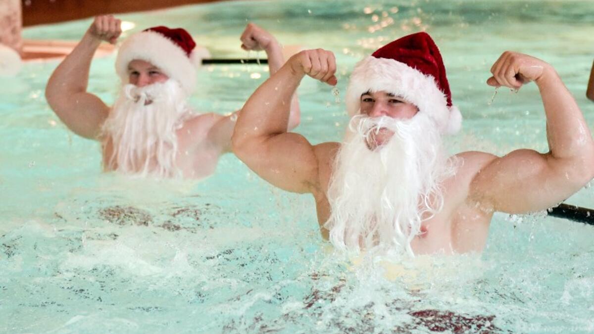 Fitness coaches dressed as Santa Claus pose while doing aqua aeorobics in a pool of the Meridian Spa in Hamburg, northern Germany, during a charity event on December 18, 2018. 
Axel Heimken / dpa / AFP