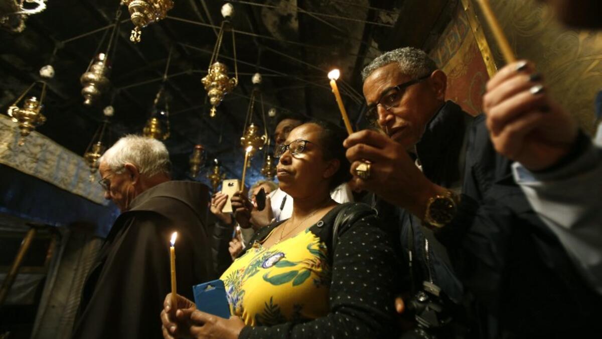 Christian worshippers pray inside the Grotto on December 22, 2018, three days ahead of the Christmas celebration. Musa Al Shaer/AFP