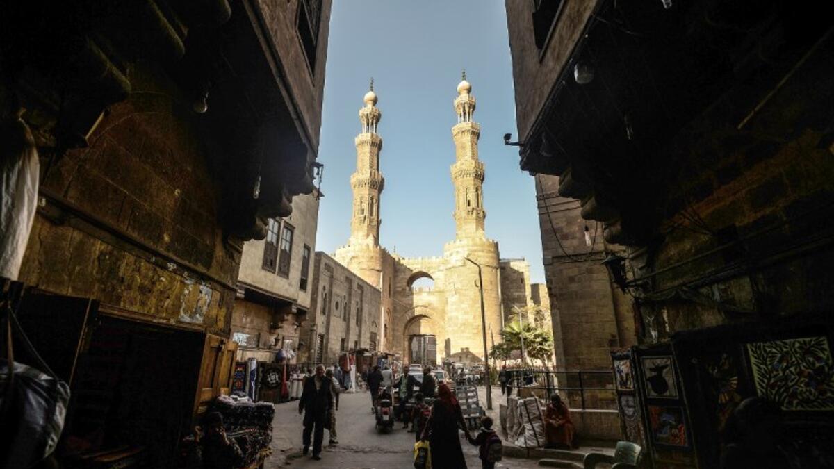 This picture shows a view from the entrance of Khayamiya Street, or the Street of Tent-makers, leading up to the 11th century Bab Zuweila, one of the surviving main gates of the old city of the Egyptian capital Cairo. 
Mohamed el-Shahed / AFP