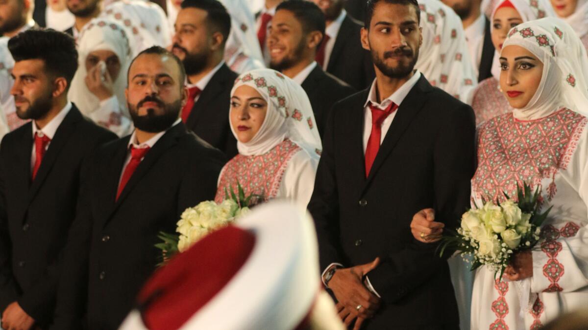 Newly-wed couples are seen during a mass wedding ceremony for 150 Palestinian couples and 50 other Lebanese couples
Mahmoud ZAYYAT / AFP