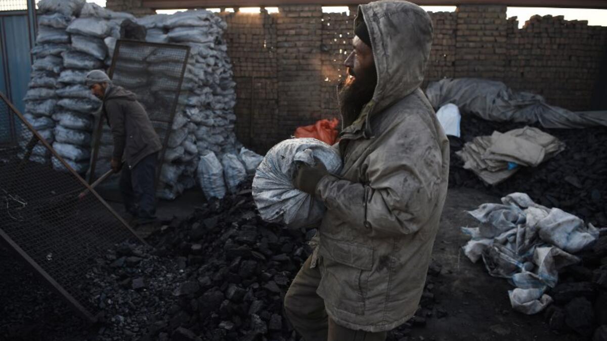 In this picture, Afghan day labourers work at a coal yard amid heavy smog conditions in the outskirts of Kabul. 
WAKIL KOHSAR / AFP