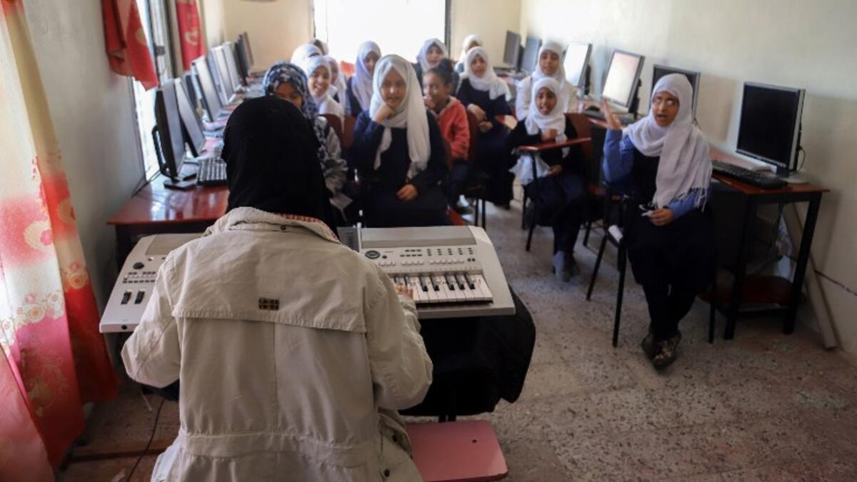 Children attend a music class at the Al-Nawras school in Taez, Yemen's third city, in the country's southwest
AHMAD AL-BASHA / AFP