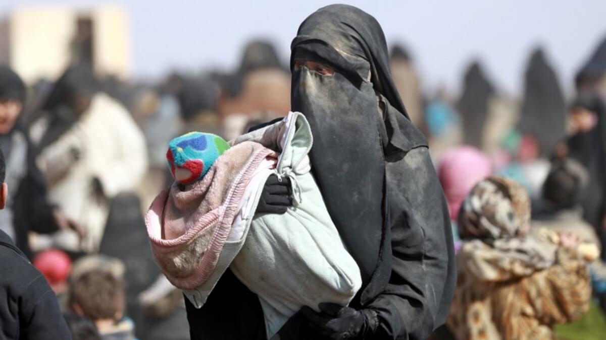 People who fled battles between Syrian Democratic Forces (SDF) and ISIS fighters in the Syrian village of Baghouz, arrive after crossing a desert in the back of a truck to a region controlled by the SFD in the countryside of the Deir Ezzor province. Delil SOULEIMAN / AFP