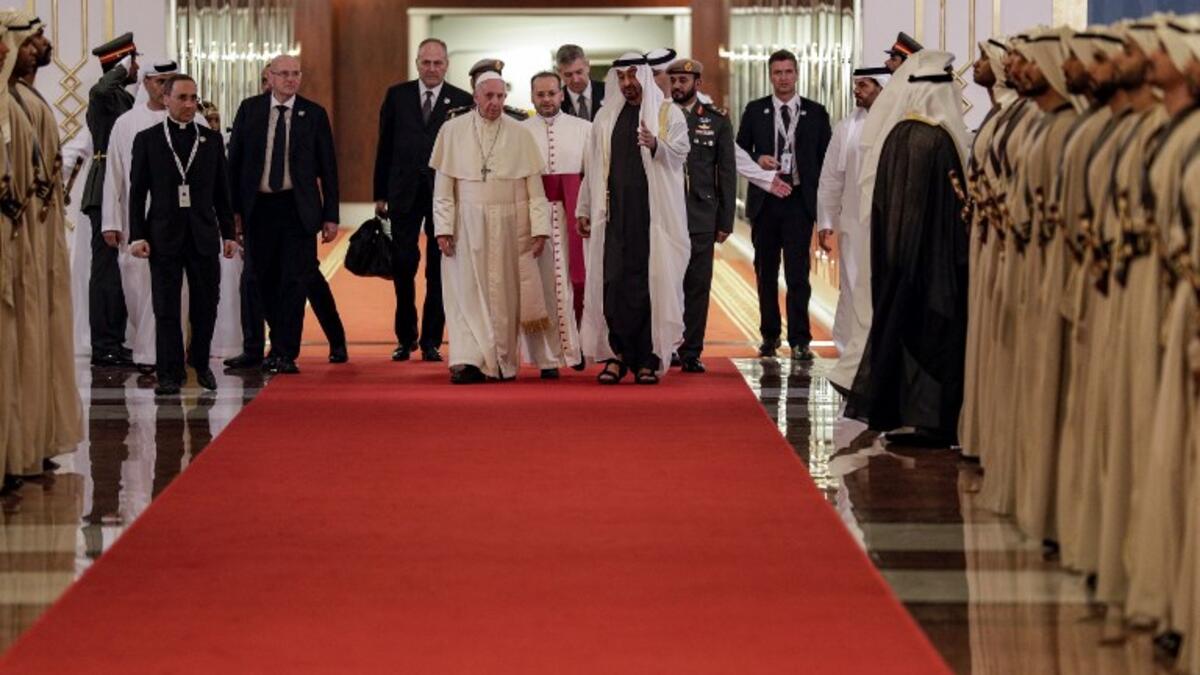 Pope Francis (C-L) is welcomed by Abu Dhabi's Crown Prince Sheikh Mohammed bin Zayed al-Nahyan (C-R) upon his arrival at Abu Dhabi International Airport in the UAE capital on February 3, 2019. 
Andrew Medichini / POOL / AFP