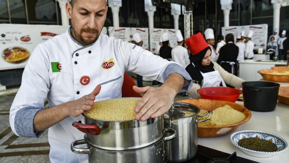 An Algerian chef prepares couscous during the 2nd edition of the International Couscous Festival at the Moufdi Zakaria Palace of Culture in  Algeria
RYAD KRAMDI / AFP
