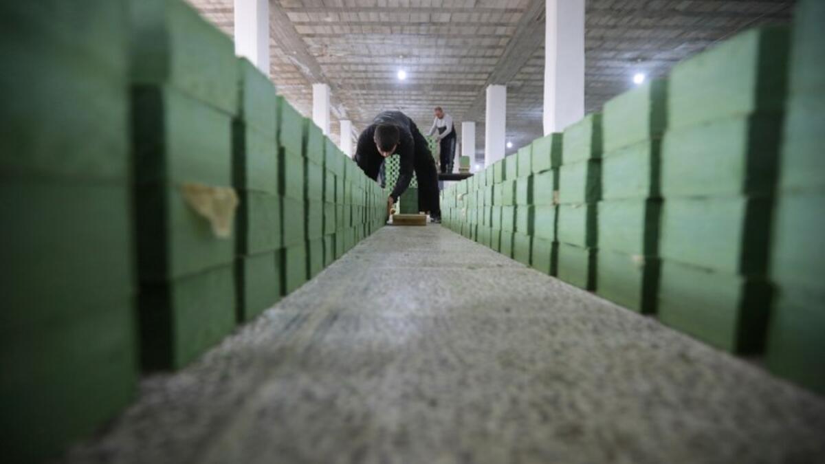 Syrian workers arrange olive soap bars in a factory on the outskirts of Aleppo 
LOUAI BESHARA / AFP
