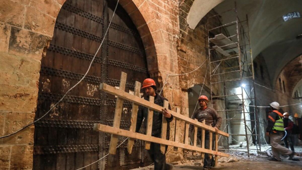 Labourers take part in restoration work at the Saqatiya market in the old quarter of Syria's second city of Aleppo 
LOUAI BESHARA / AFP