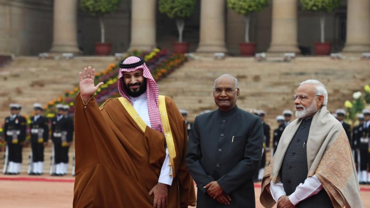 Saudi Crown Prince Mohammed bin Salman (L) waves while posing for media with Indian President Ram Nath Kovind (C) and Indian Prime Minister Narendra Modi during ceremonial reception at Presidential palace in New Delhi 
Prakash SINGH / AFP