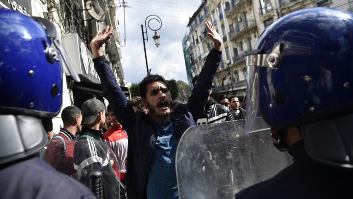 Members of the security forces stand guard as Algerian students protest in the capital Algiers against ailing President Abdelaziz Bouteflika's bid for a fifth term
RYAD KRAMDI / AFP