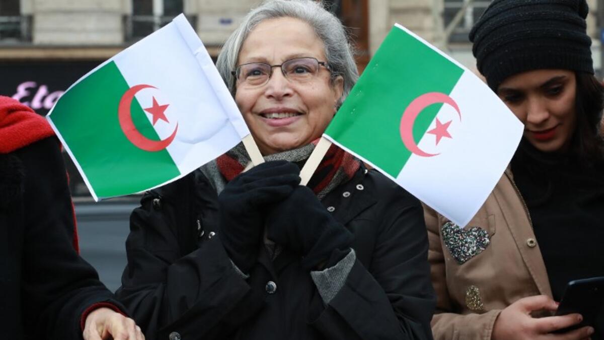 A woman holds Algerian flags during a rally against ailing Algerian president's decision to stand for a fifth term in office
JACQUES DEMARTHON / AFP
