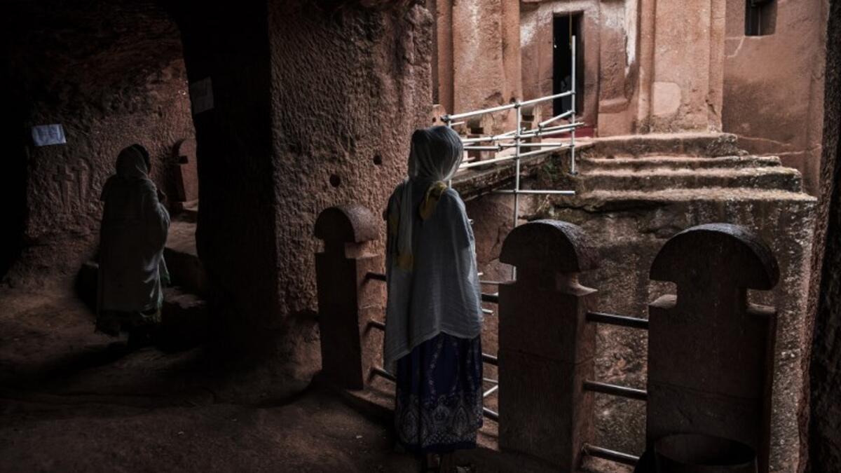 Ethiopian Orthodox devotees stand between the rock-hewn churches of Saint Gabriel and Saint Raphael in Lalibela, Ethiopia
EDUARDO SOTERAS / AFP