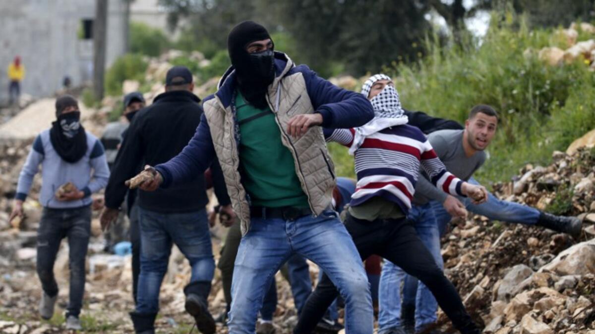 Palestinian protesters throw stones towards Israeli forces during clashes following a weekly demonstration against the expropriation of Palestinian land by Israel in the village of Kfar Qaddum, near Nablus 
JAAFAR ASHTIYEH / AFP